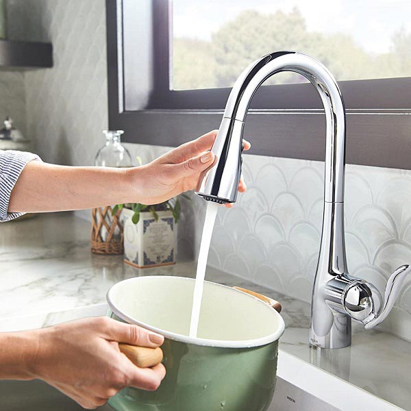 Pulldown faucet is used to fill a cooking pot with water