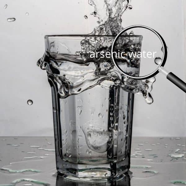 glass of water with arsenic water under magnifying glass
