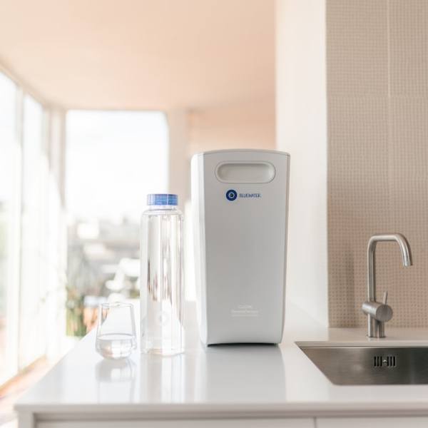 reverse osmosis water filter and a glass of water