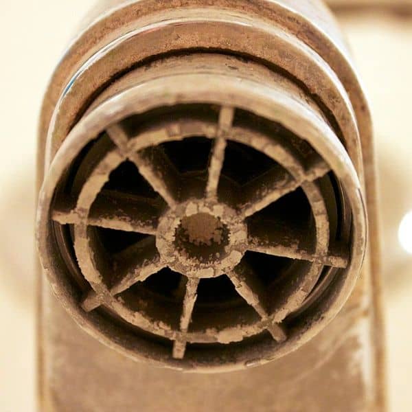 A tub faucet with built-up calcification from hard water in Southern Arizona