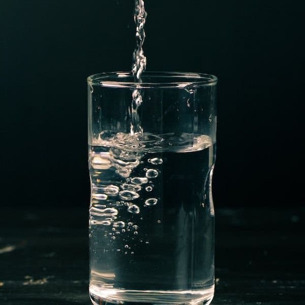 distilled water pouring in a glass