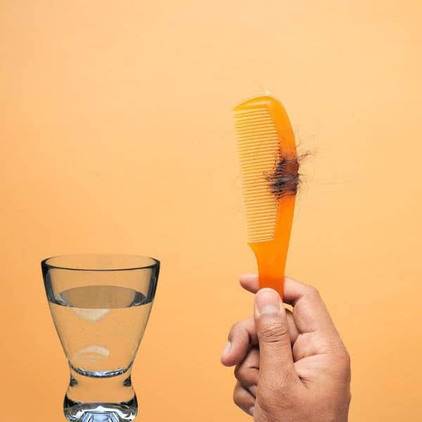 iron in a glass of water and falling hair in a comb
