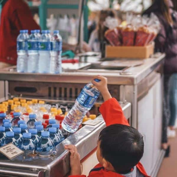 child buying distilled water